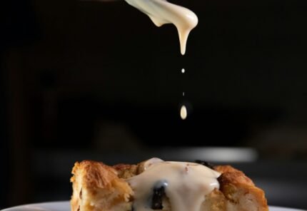 person holding stainless steel fork with white cream